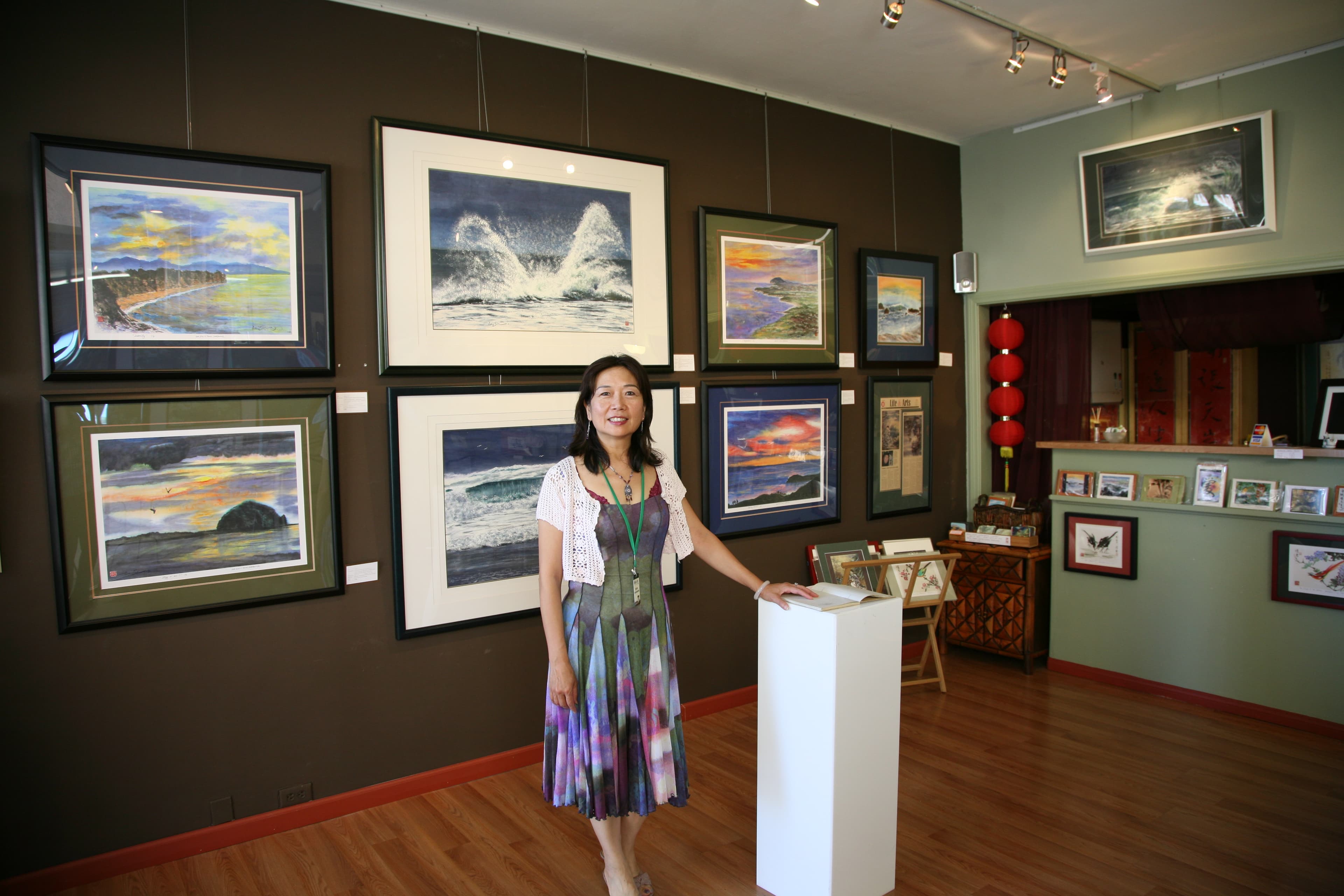 Waisin standing in front of her art in her previous studio